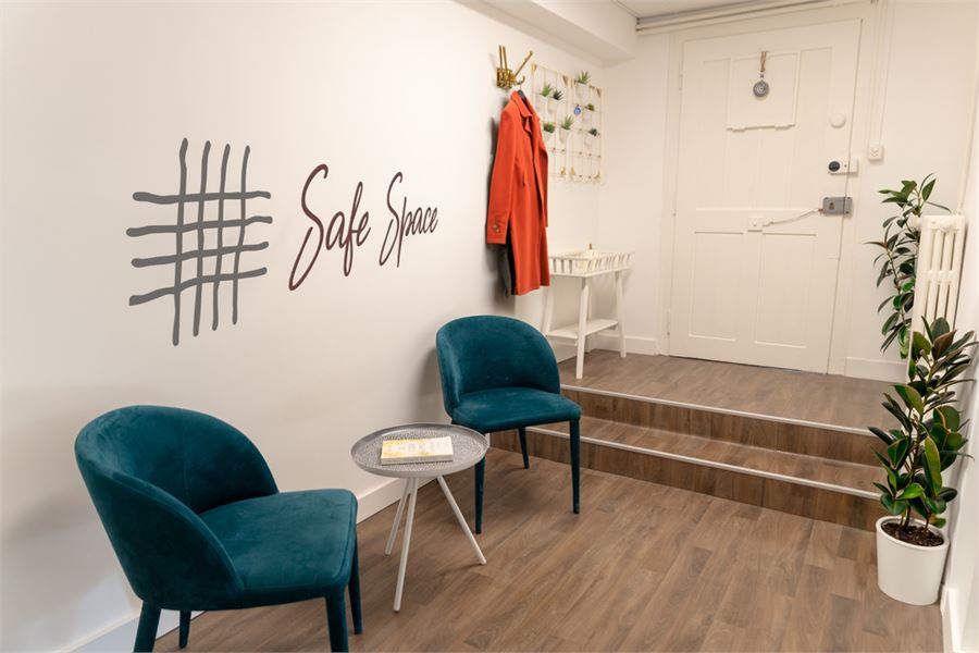 Le hall d'accueil de Safe Space, avec ses fauteuils et le logo peint au mur